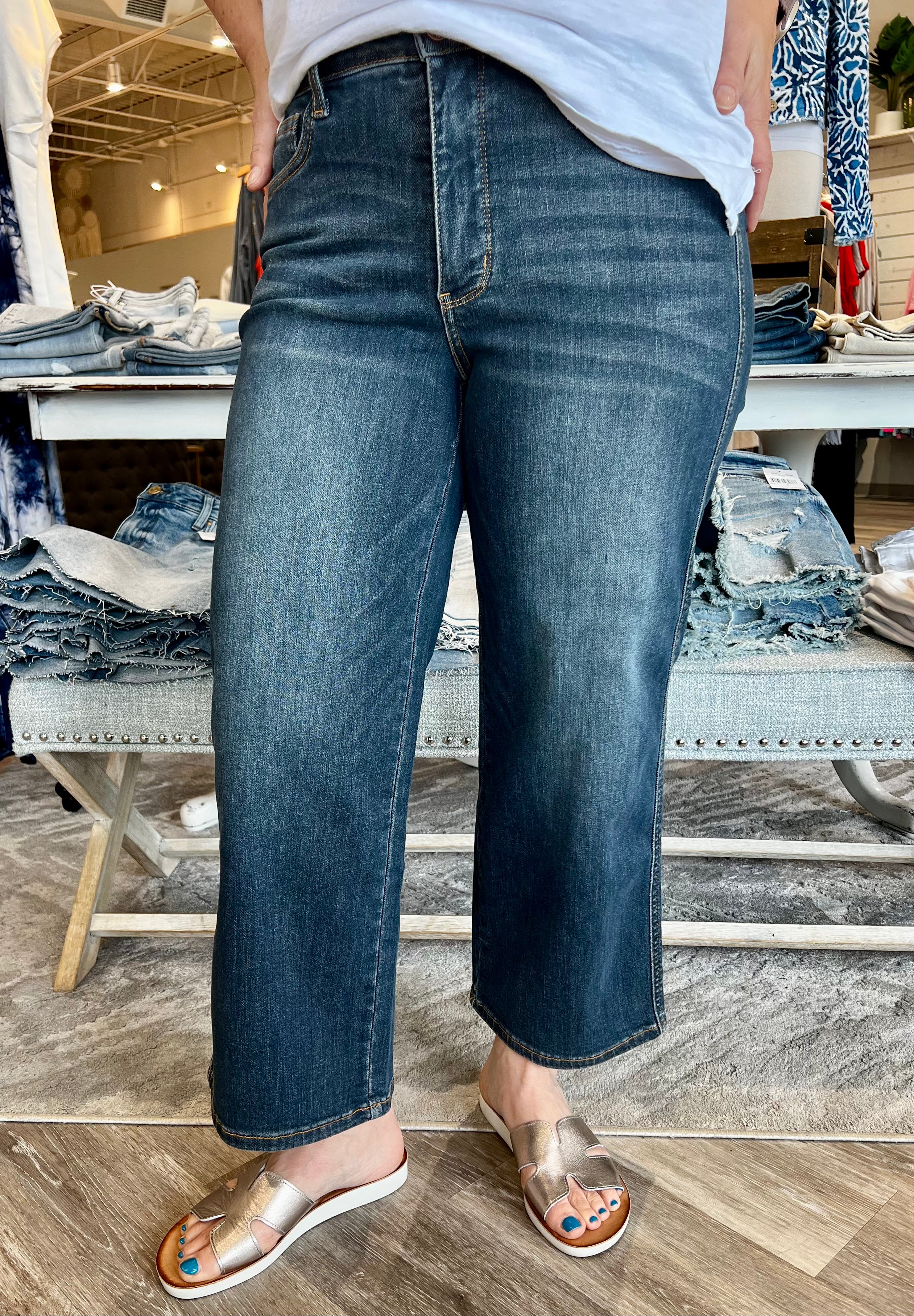 Introducing the latest in chic comfort: the Judy Blue wide leg cropped jeans, designed to revolutionize your wardrobe. These jeans are not just a fashion statement; they're an embodiment of style and functionality, perfect for anyone looking to enhance their wardrobe with a versatile piece that transitions seamlessly from day to night.