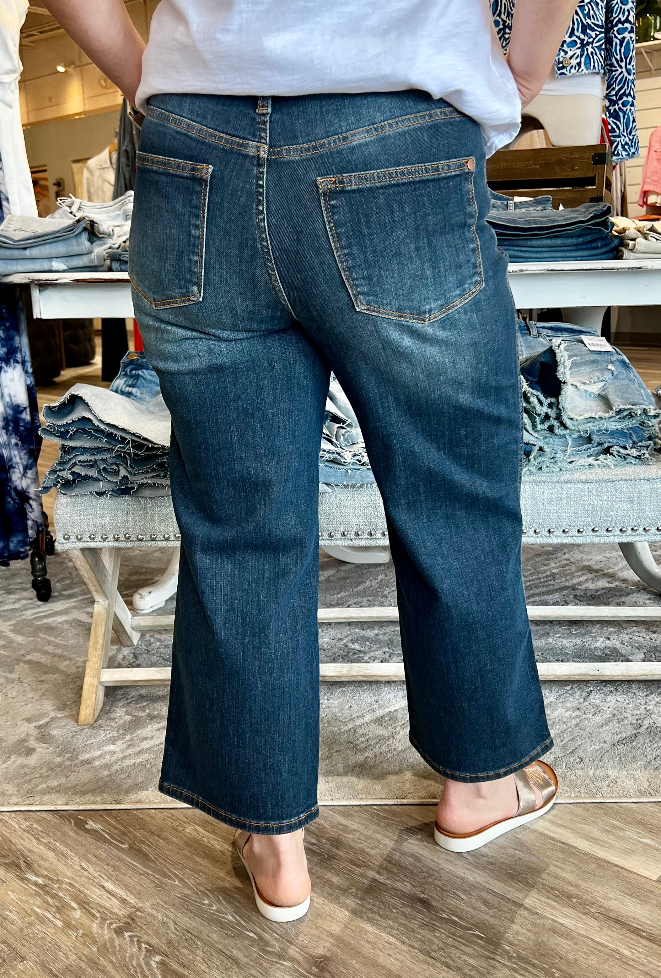 Introducing the latest in chic comfort: the Judy Blue wide leg cropped jeans, designed to revolutionize your wardrobe. These jeans are not just a fashion statement; they're an embodiment of style and functionality, perfect for anyone looking to enhance their wardrobe with a versatile piece that transitions seamlessly from day to night.