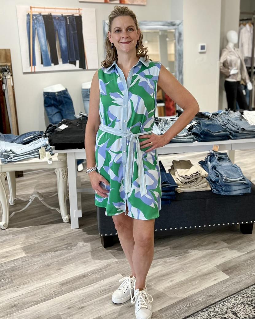 Warm days call for this effortless sleeveless shirt dress, featuring a bold print on the front and a contrasting back. An adjustable tied sash cinches the waist, providing a comfortable and defined fit.
