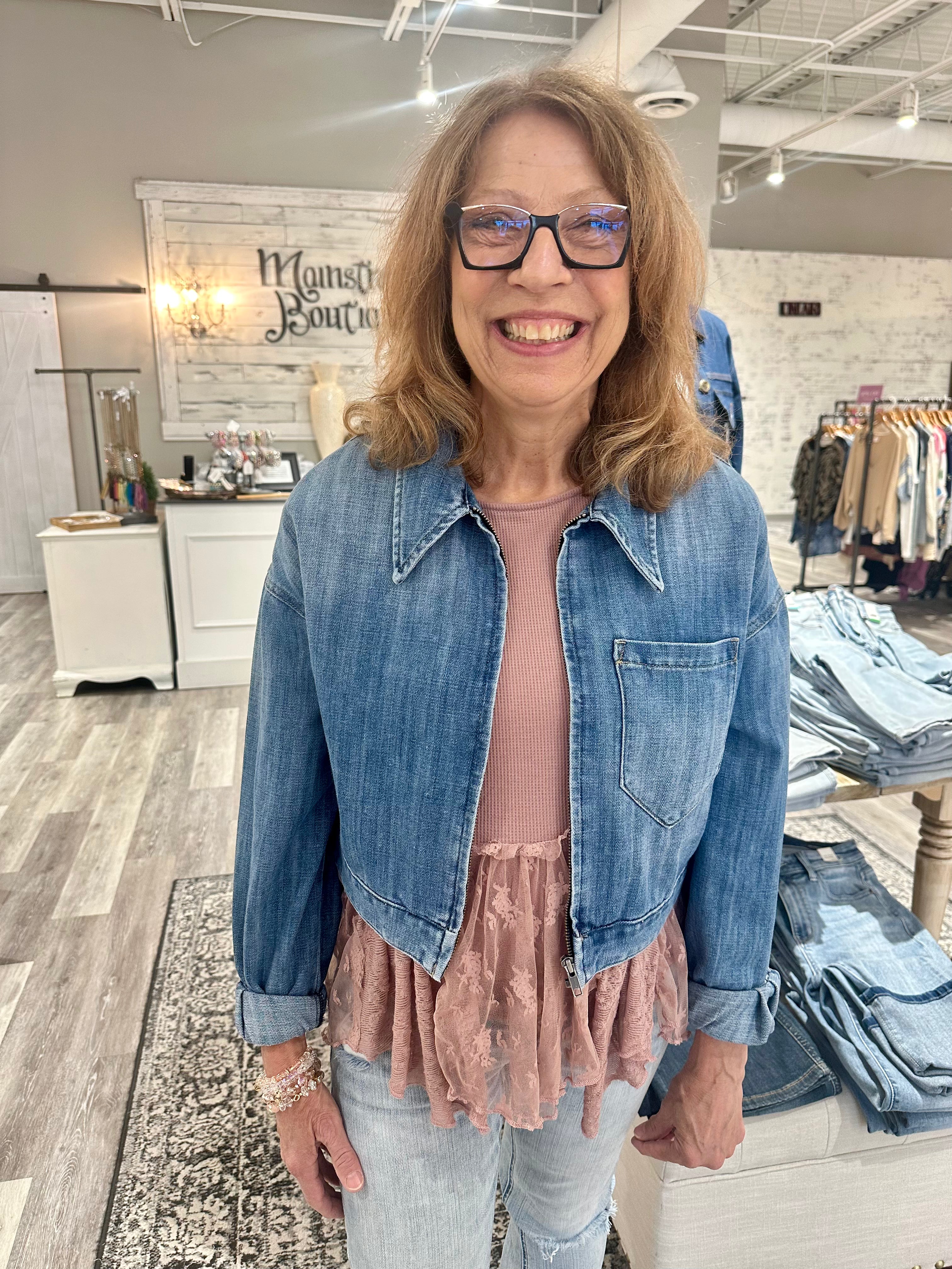 The top collar and long sleeves add a touch of sophistication, while the zip down front and cropped silhouette create a modern, stylish look. The medium wash adds versatility, making this jacket the perfect addition to any wardrobe.

Runs true to size
79% Cotton, 21% Spandex 
