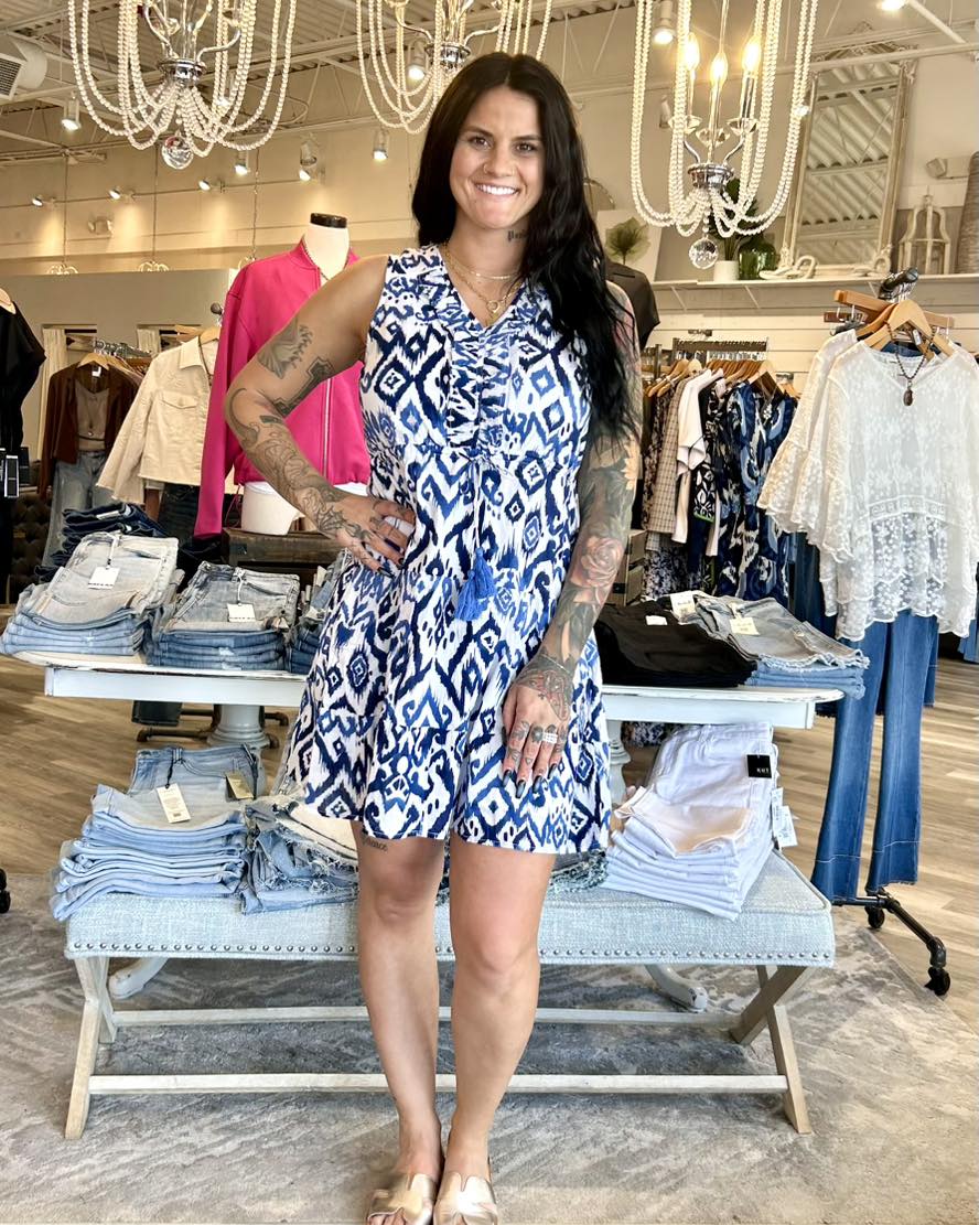 A sleeveless cotton ruffle dress is a delightful way to add warmth and joy to your wardrobe. Featuring a vibrant blue Ikat print, it blends bohemian flair with a playful touch. The lightweight fabric and knee-length tiered design keep you comfortable as you move. Perfect for sunny days and breezy evenings all spring and summer.

Knee length
V-neck with ruffle details
Waist drawstring
Tiered design
Sleeveless
100% cotton